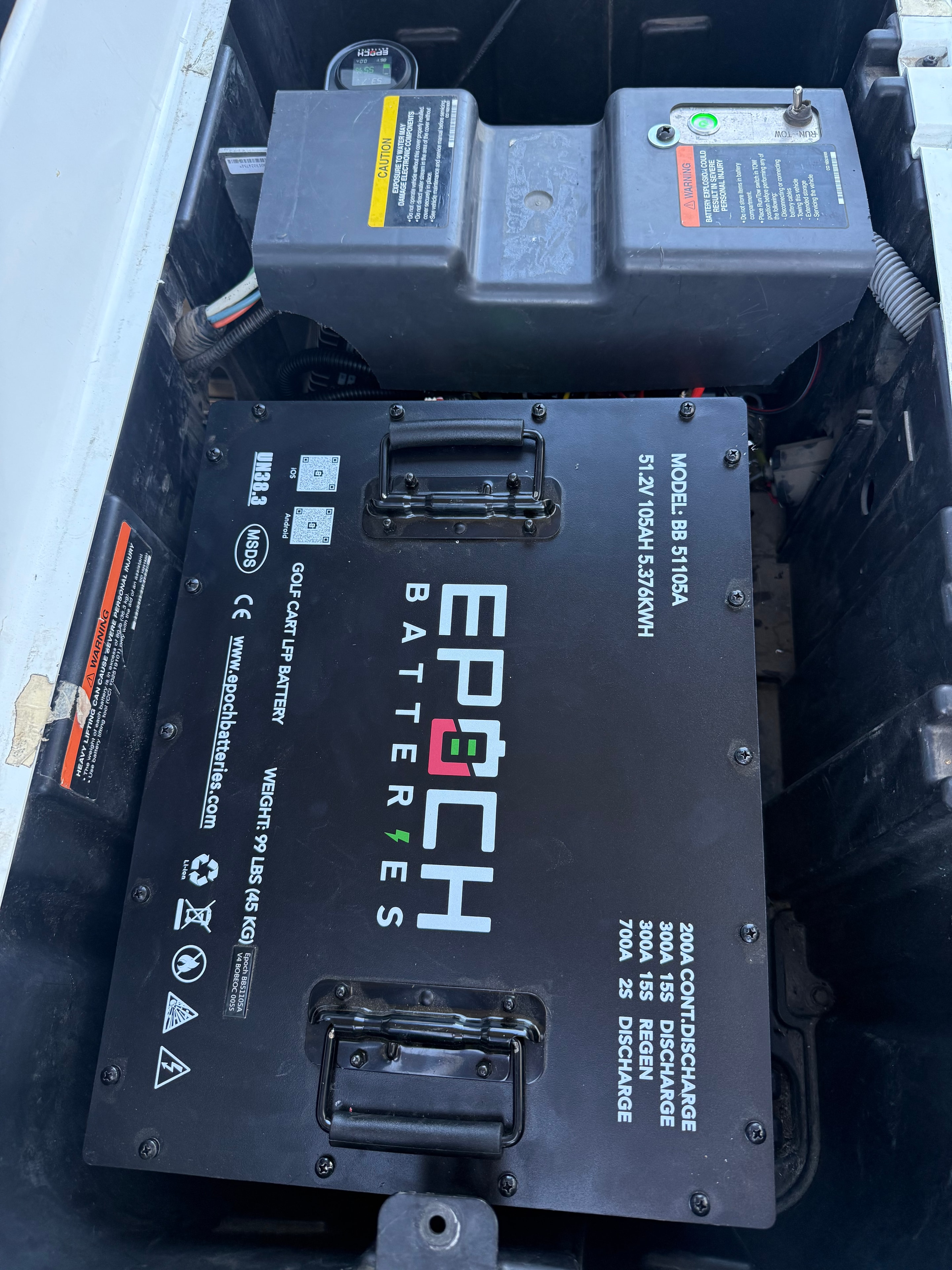 Epoch lithium golf cart battery installed beside electrical components