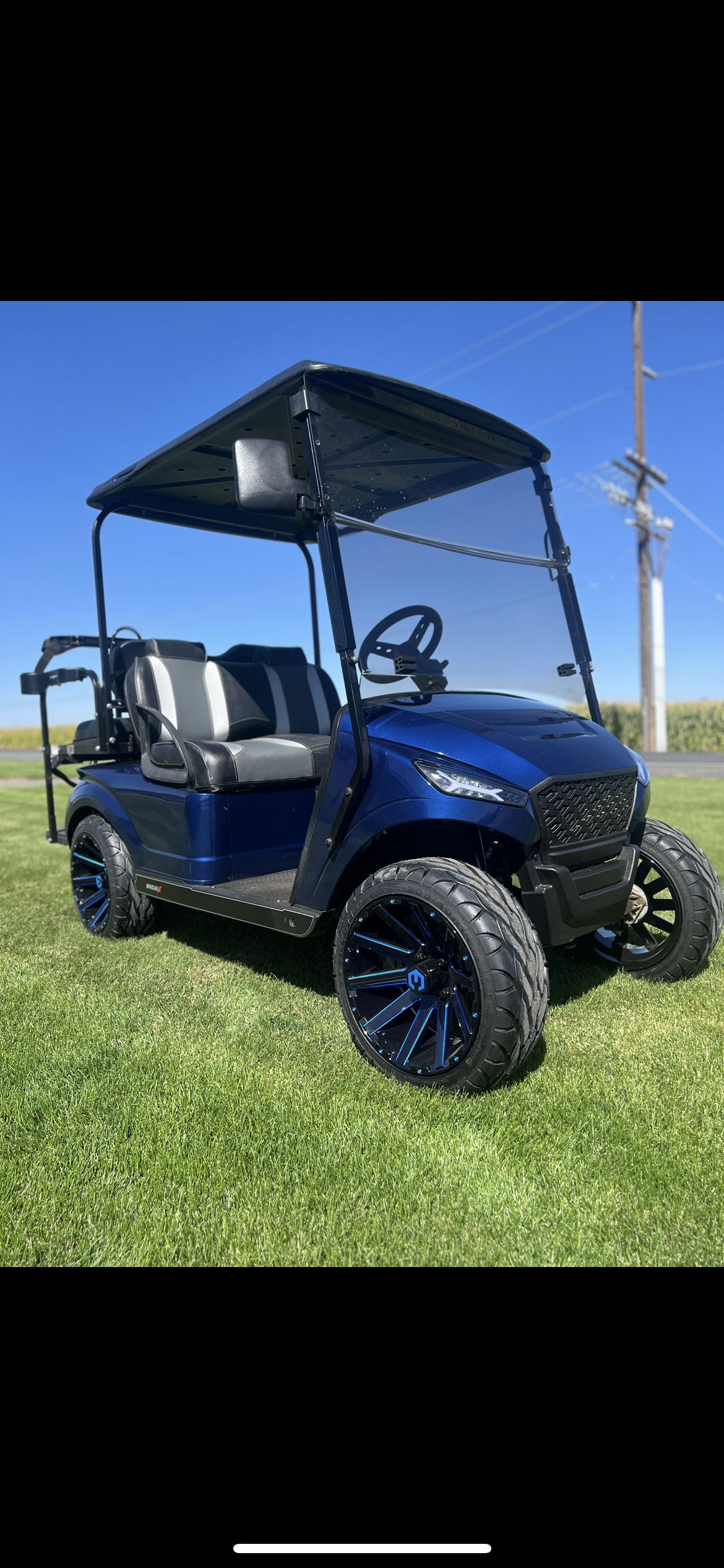 Blue custom golf cart with black seats and black wheels