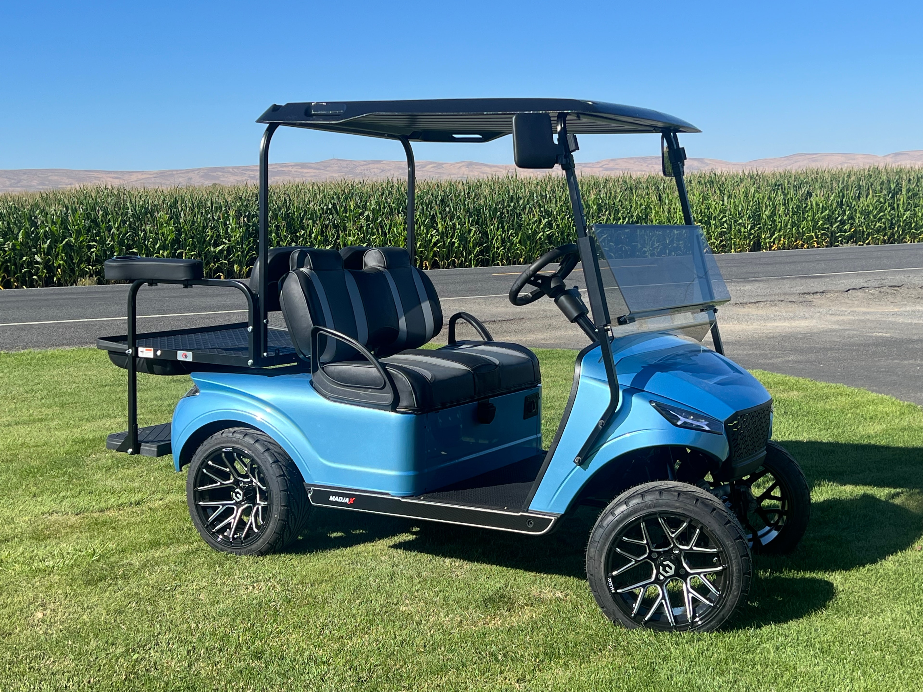 Blue custom golf cart with rear utility seat and bag rack