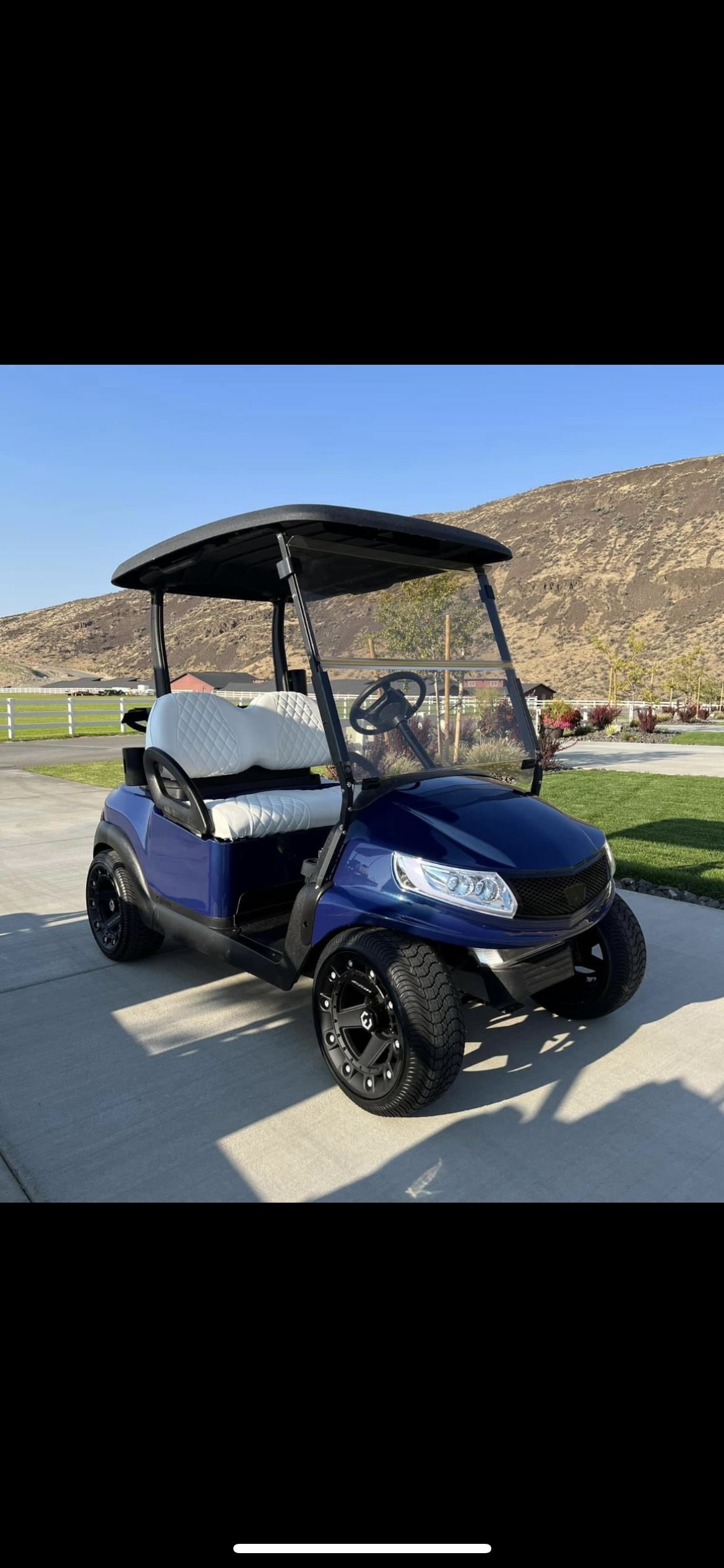 Blue custom golf cart with white quilted seats