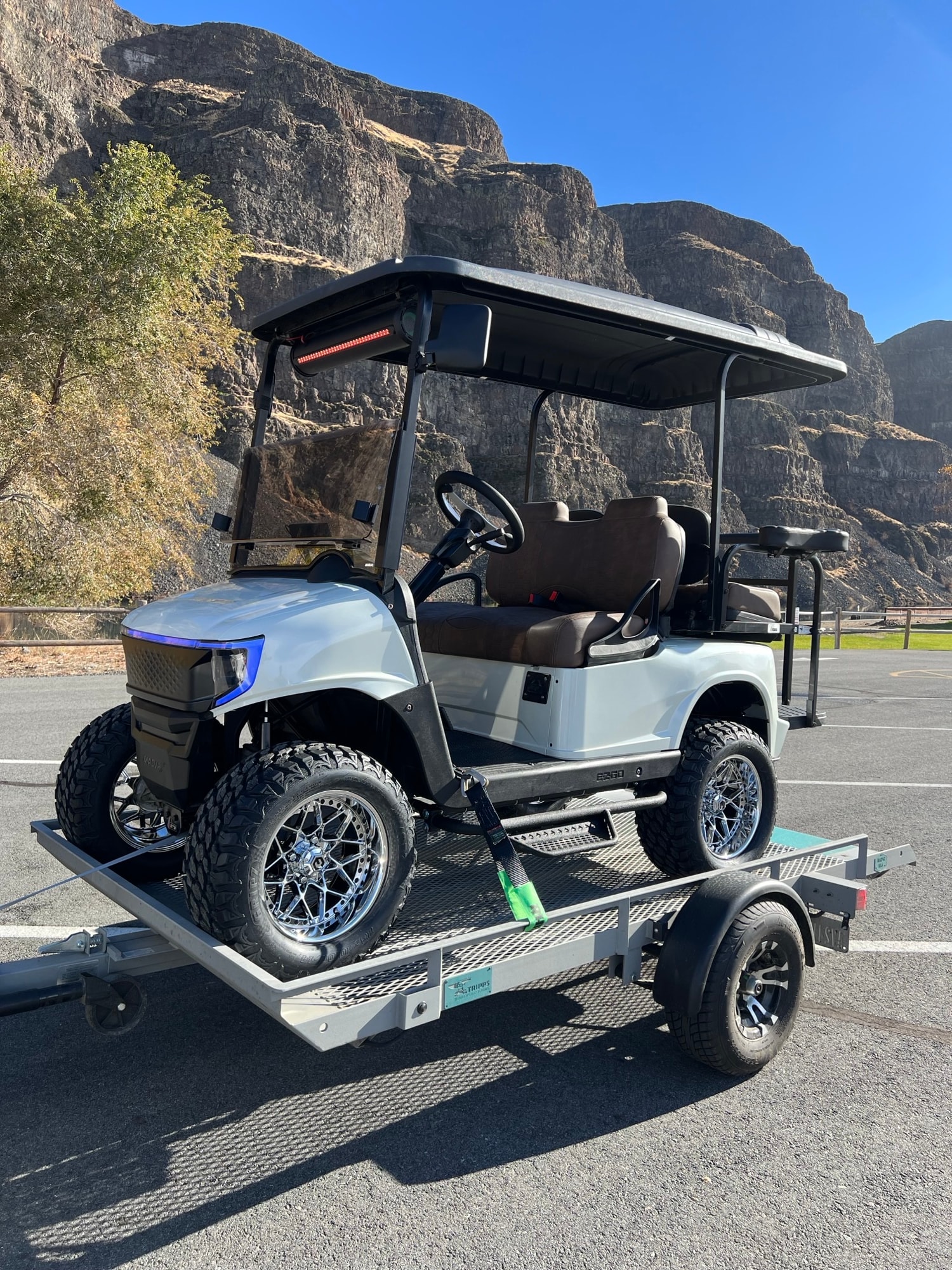 Golf cart trailer with mountain cliffs in the background