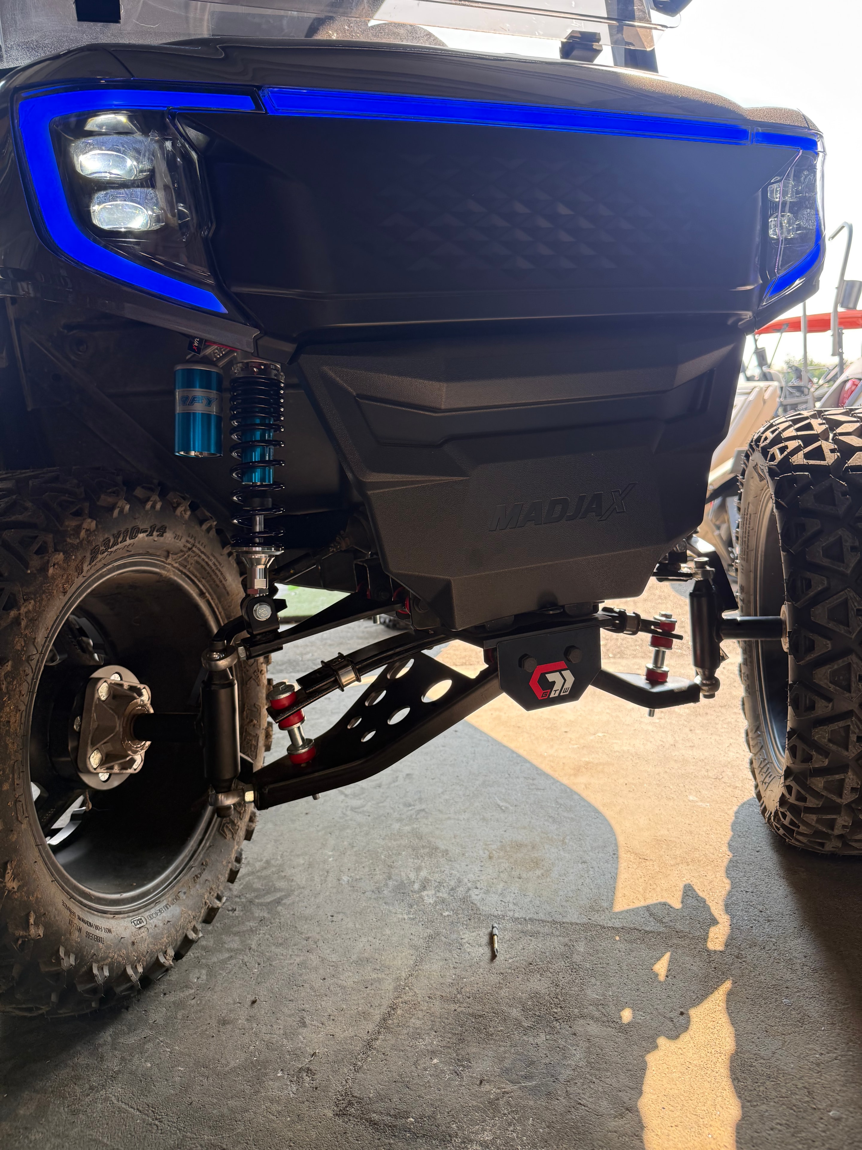 Custom golf cart with blue lighting and upgraded suspension
