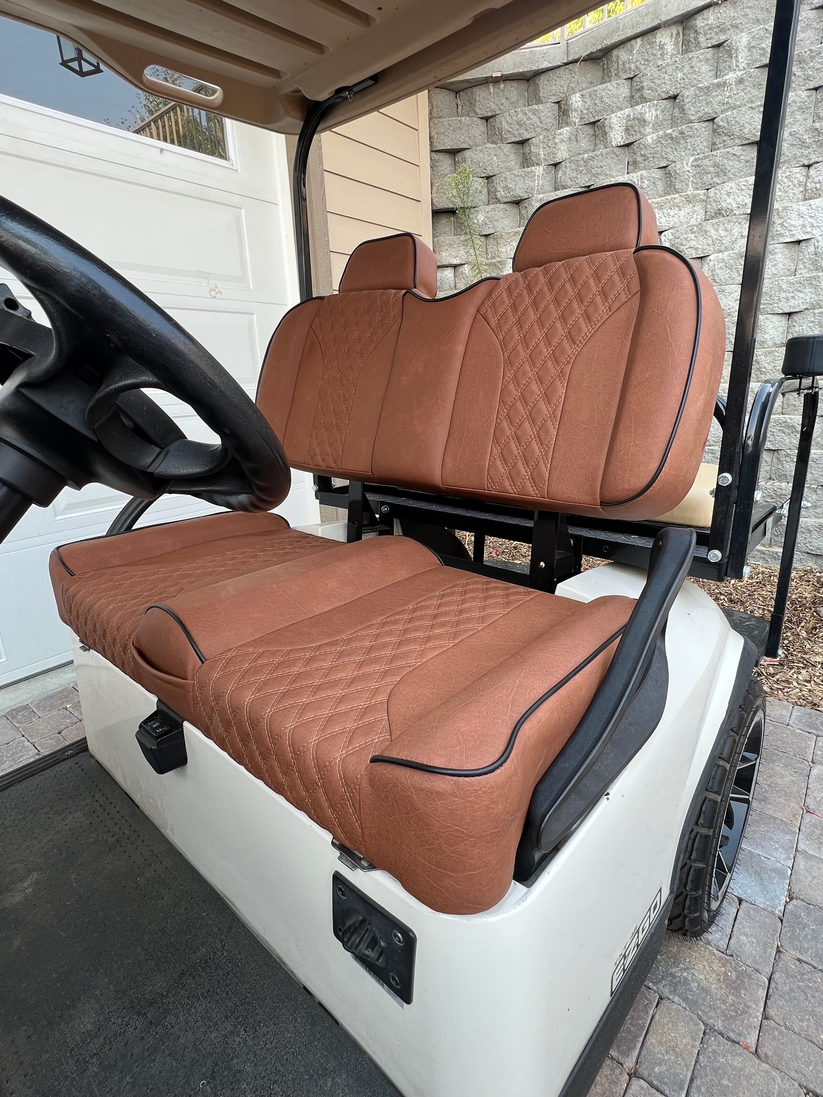 White golf cart with brown quilted custom seats