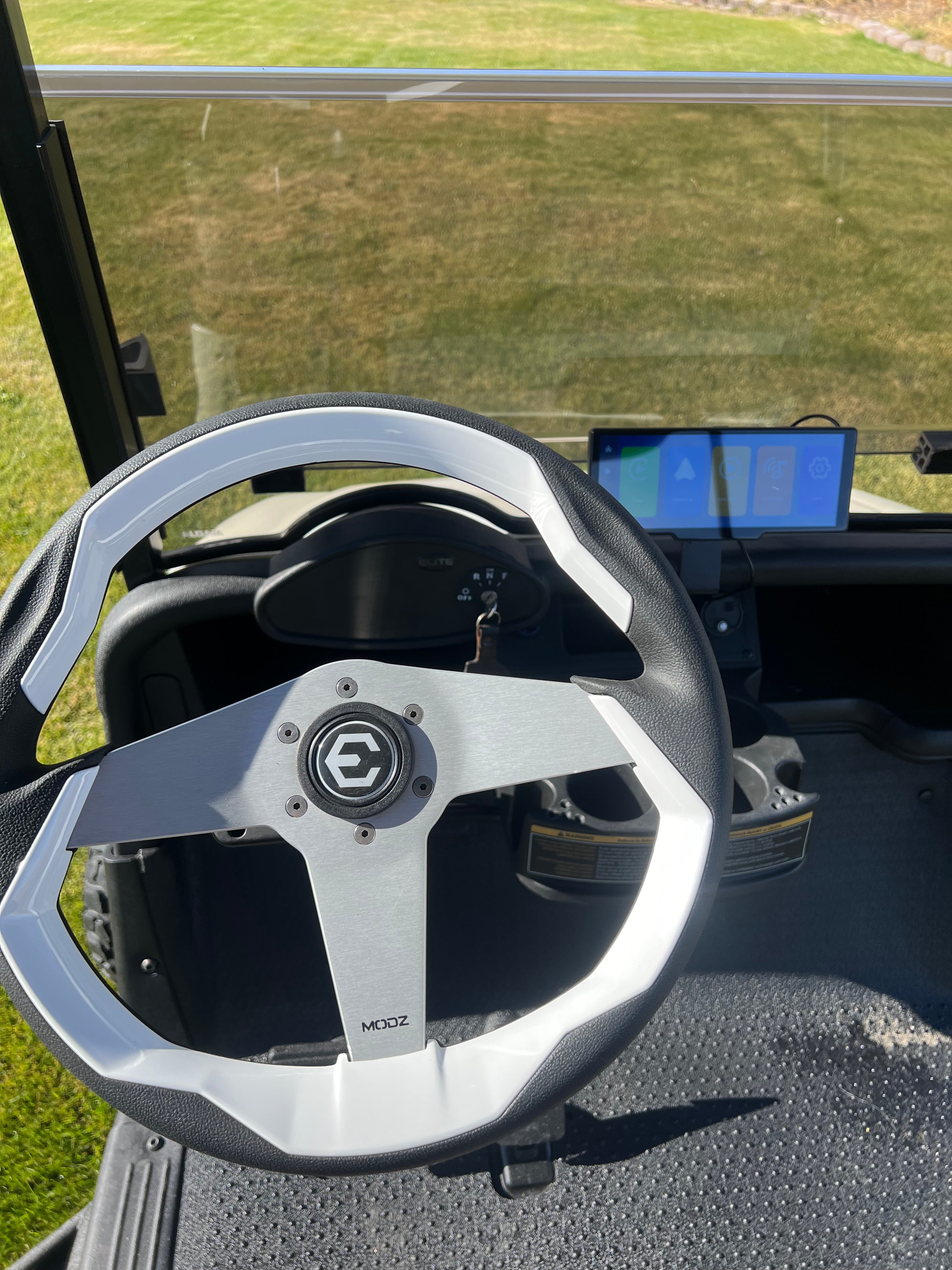 Custom brushed-metal golf cart steering wheel and dashboard
