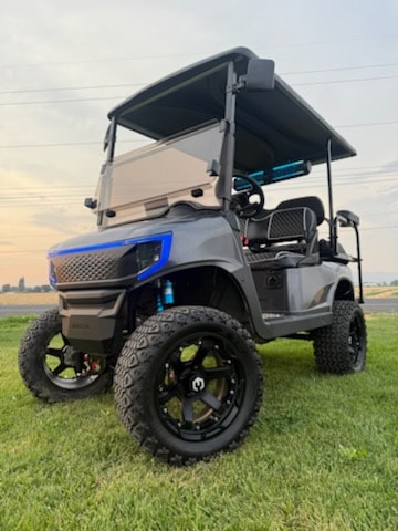 Gray lifted golf cart with blue LED lighting