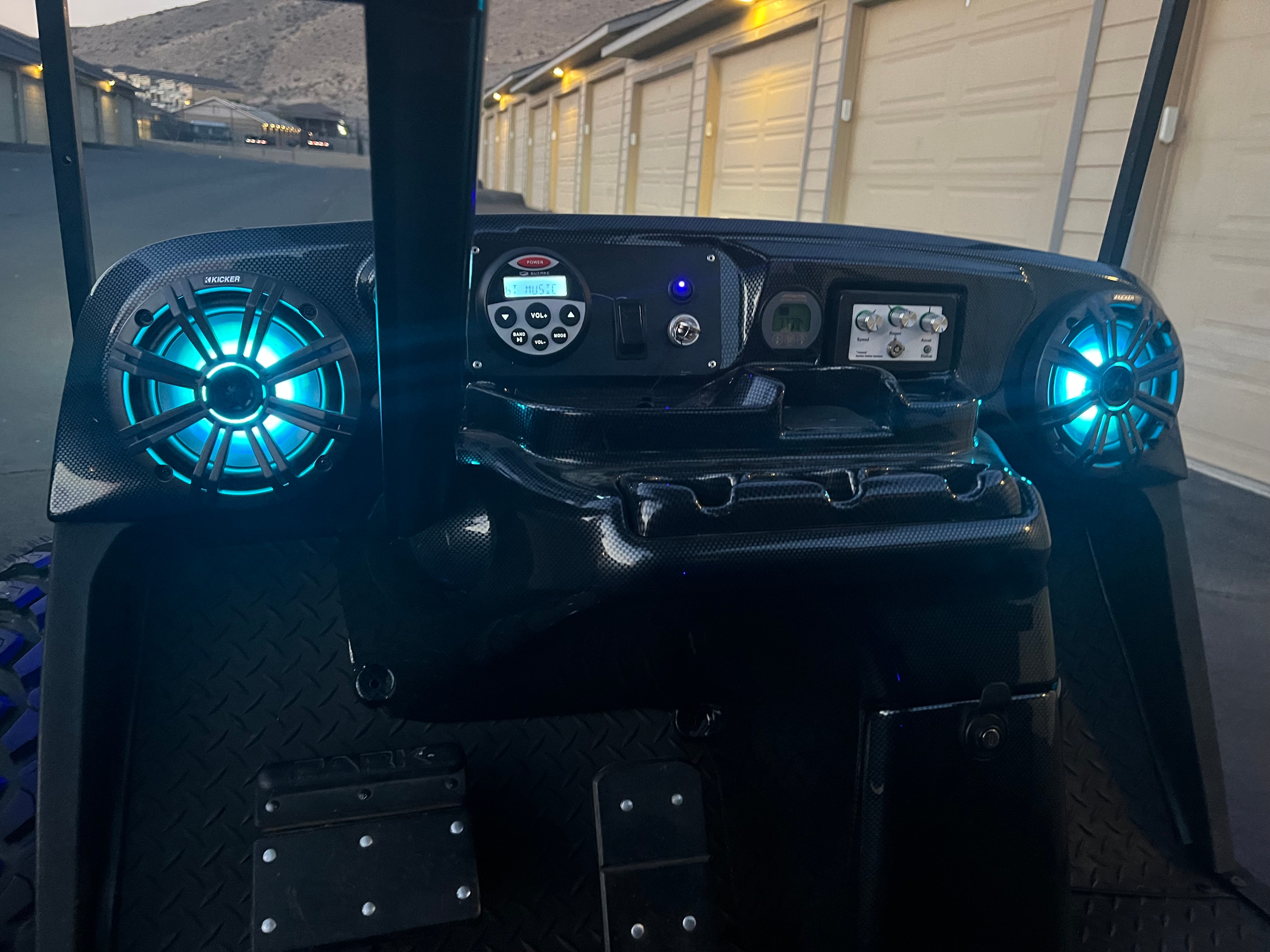 Custom golf cart dashboard with green illuminated speakers
