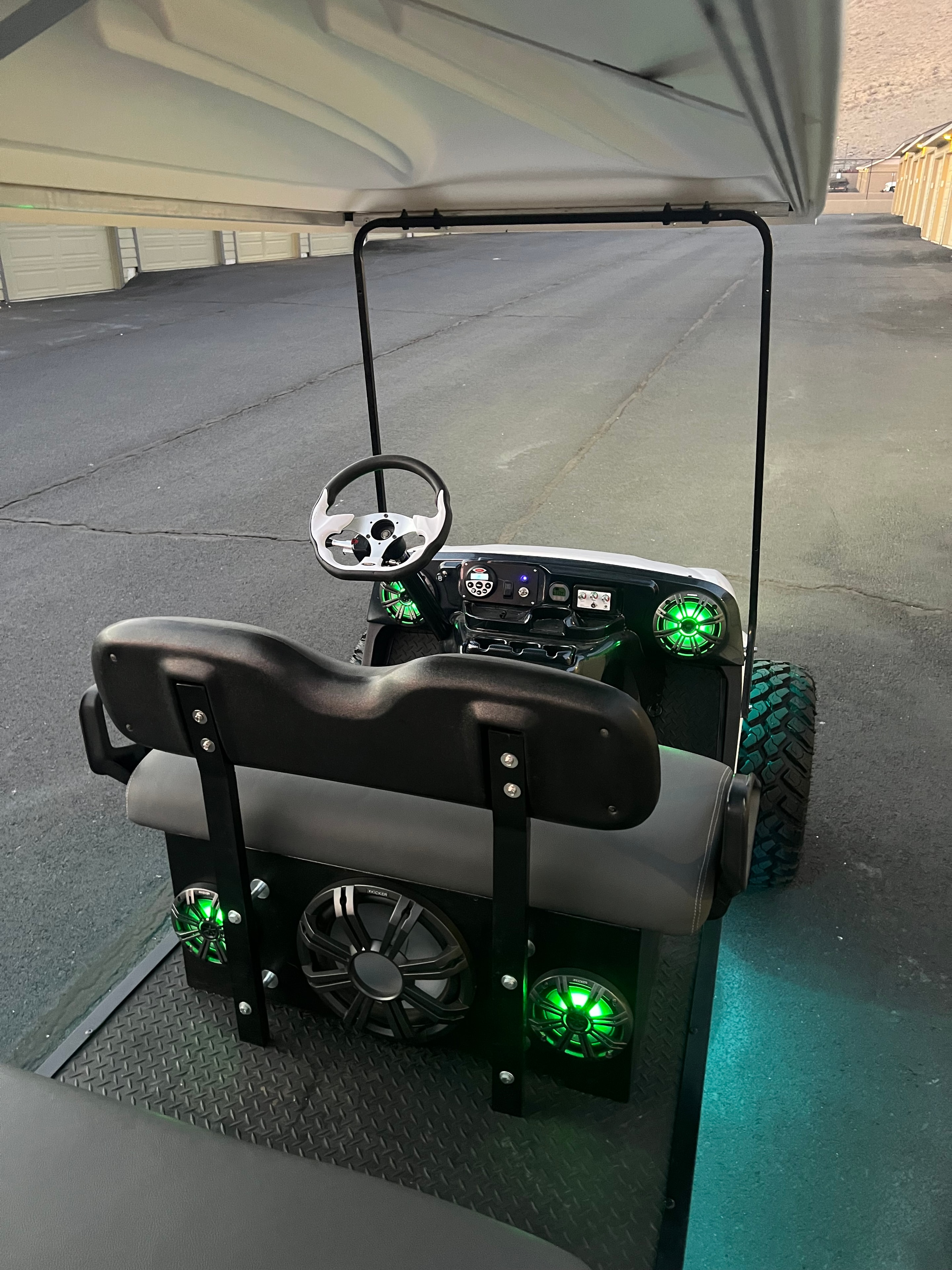 Custom golf cart rear seats with green illuminated speakers