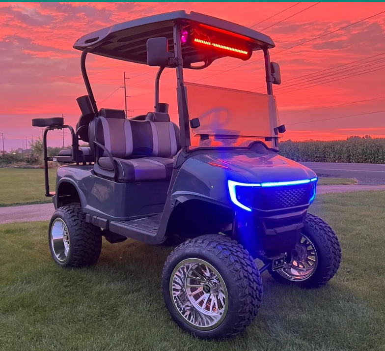 Custom golf cart with LED lights at sunset
