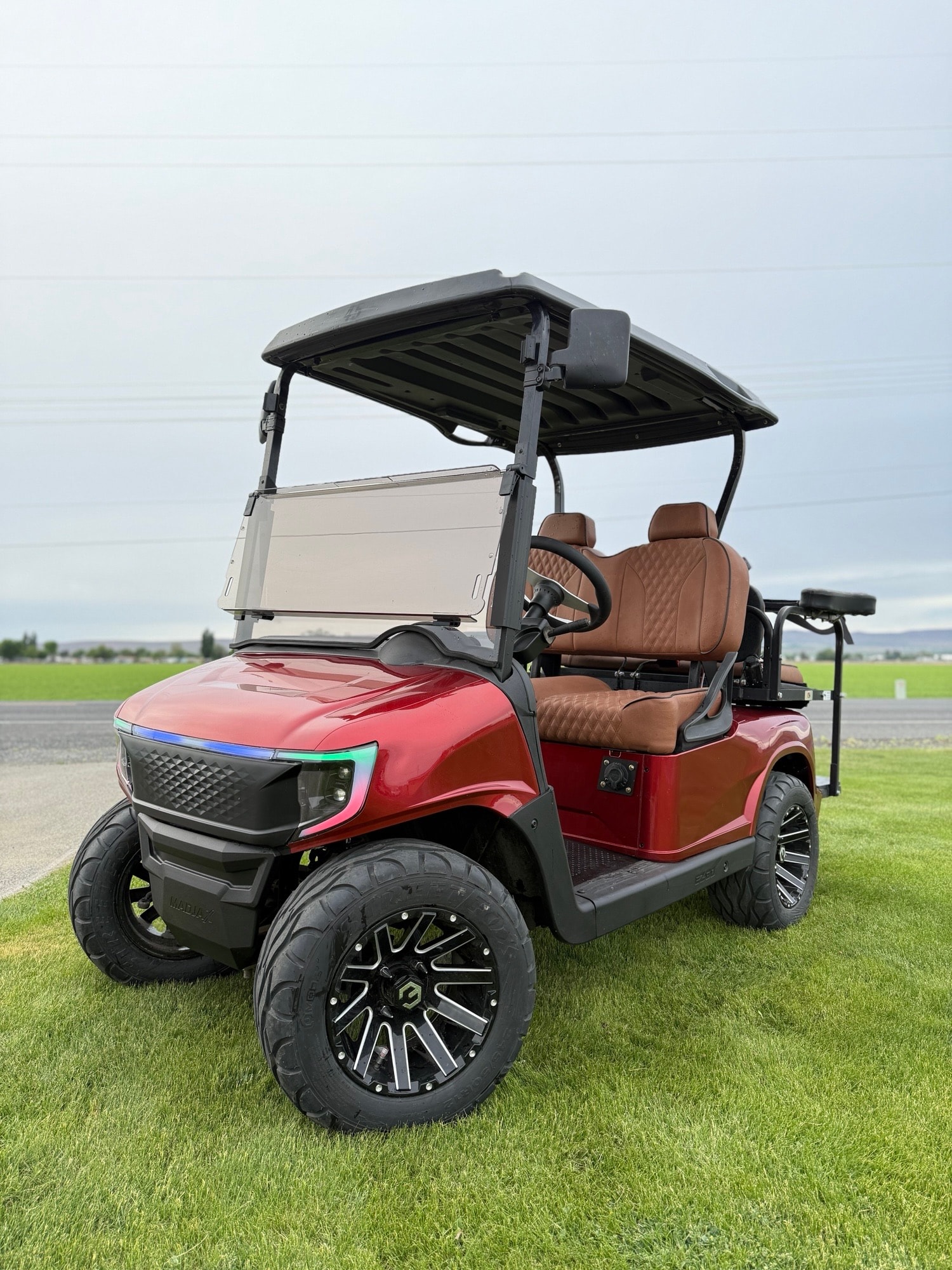 Red golf cart parked on grass
