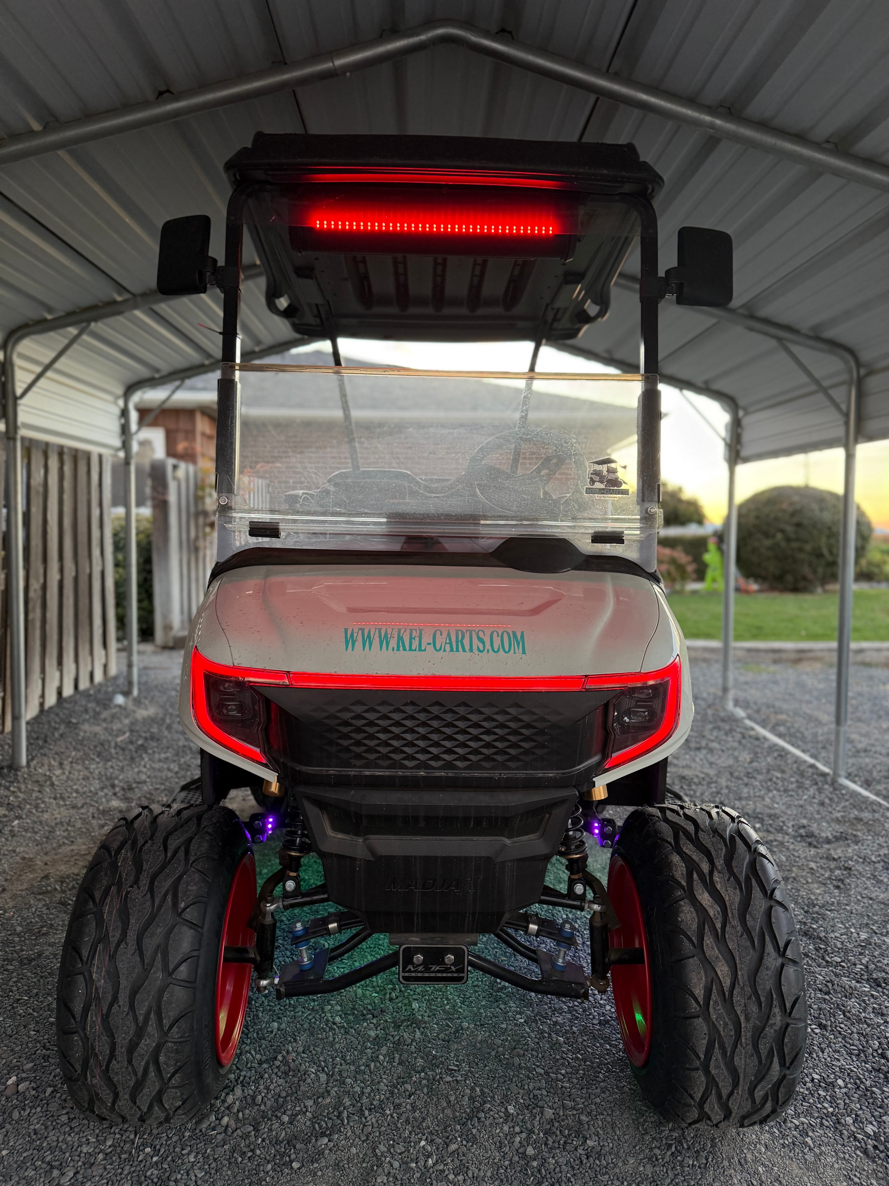 Red lifted golf cart with LED lights