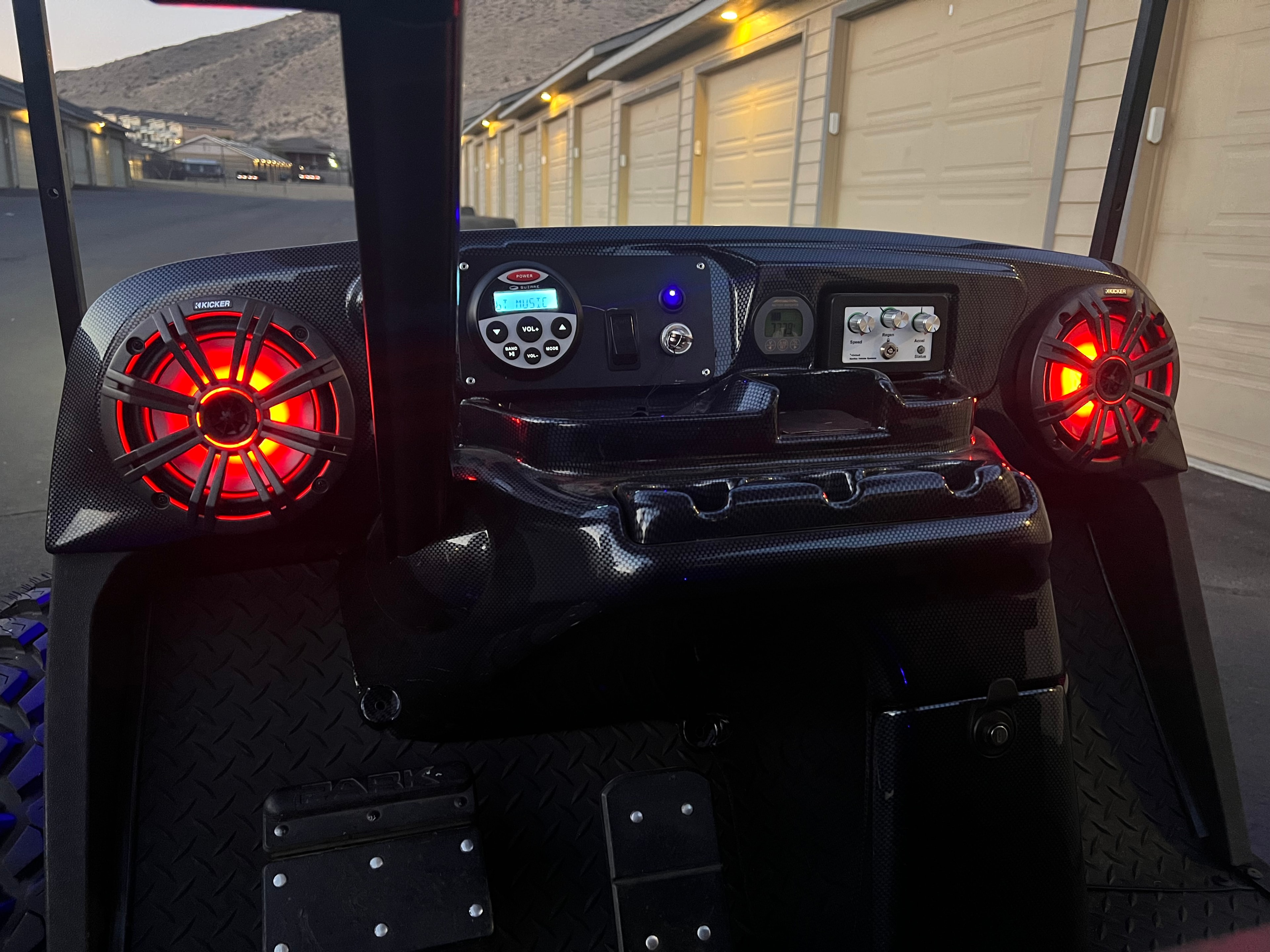 Custom golf cart dashboard with red illuminated speakers