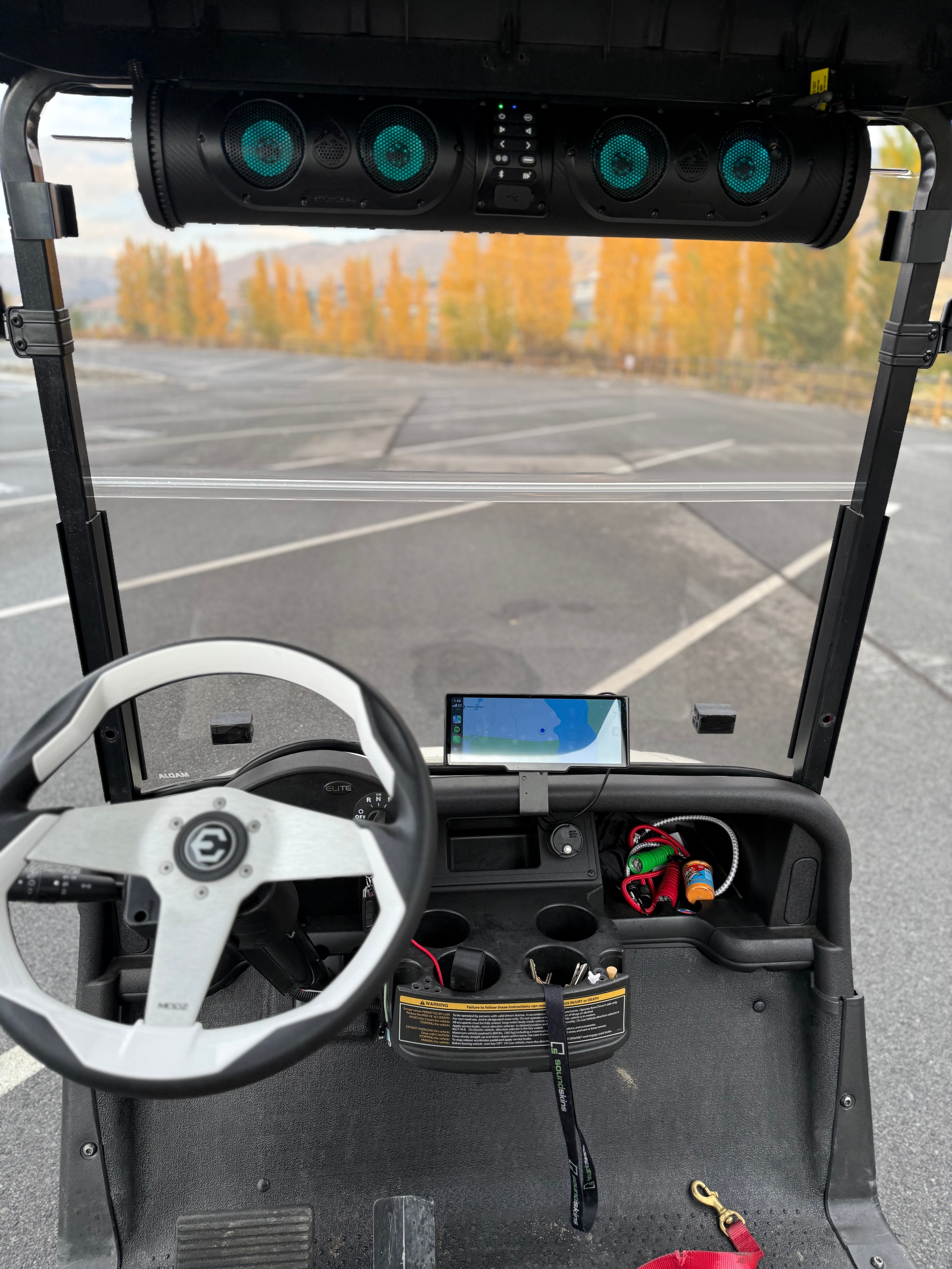 Custom golf cart dashboard with teal illuminated audio system