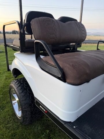 White golf cart with brown seats