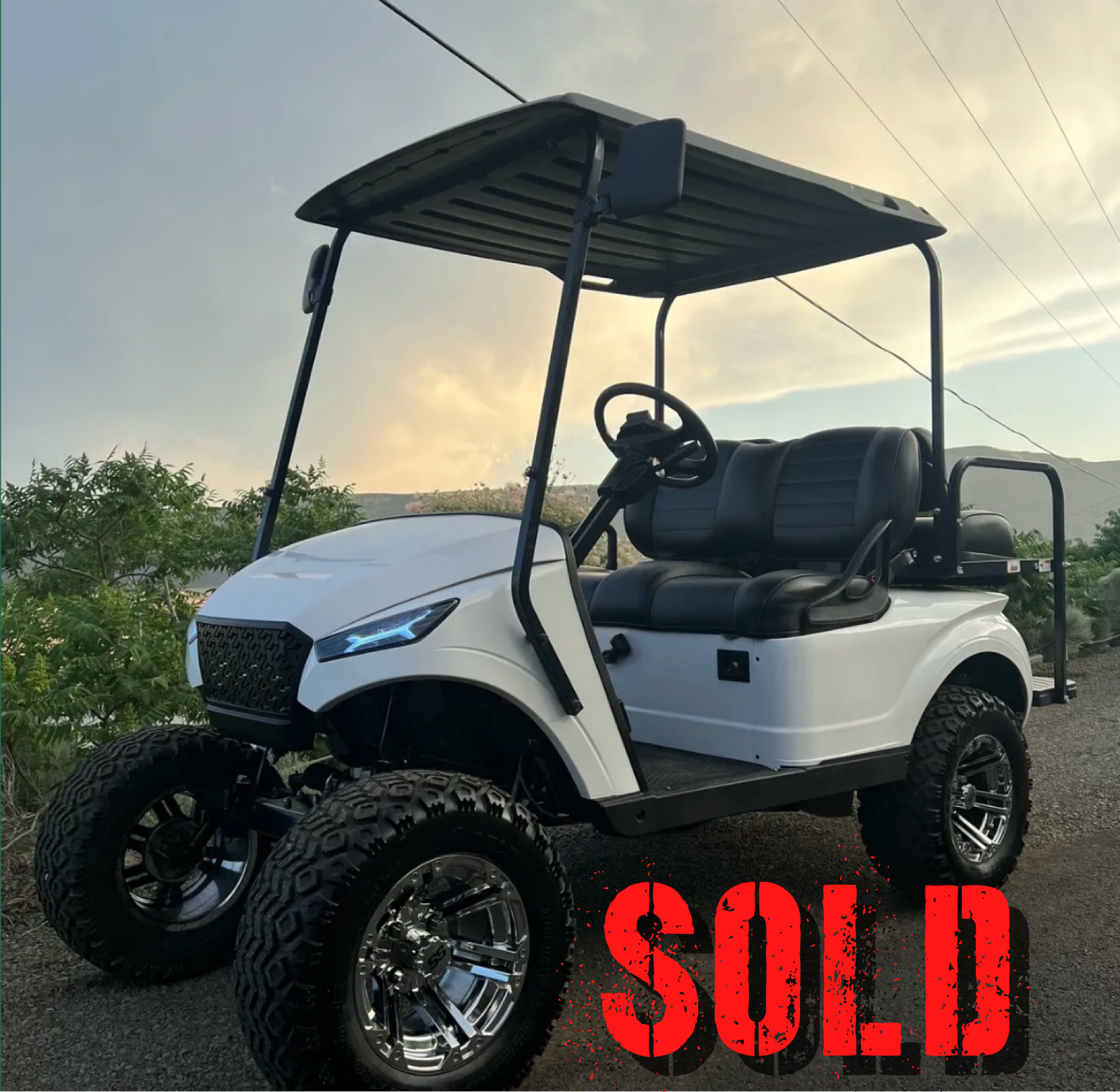 White lifted golf cart with oversized tires
