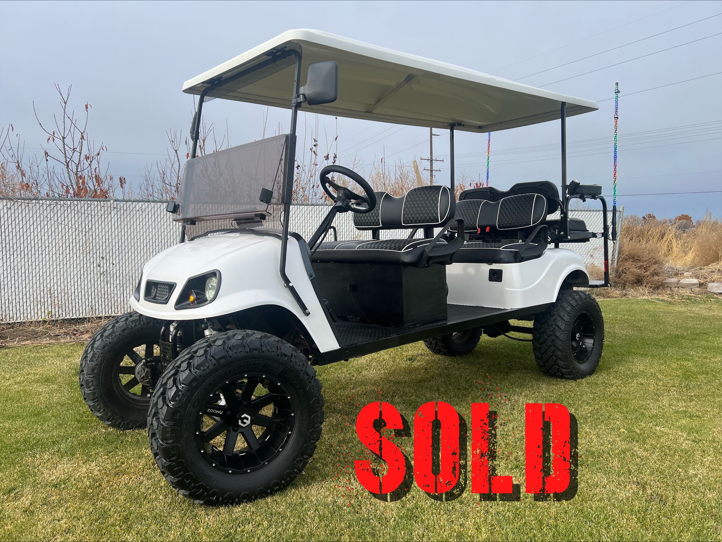 White lifted off-road golf cart