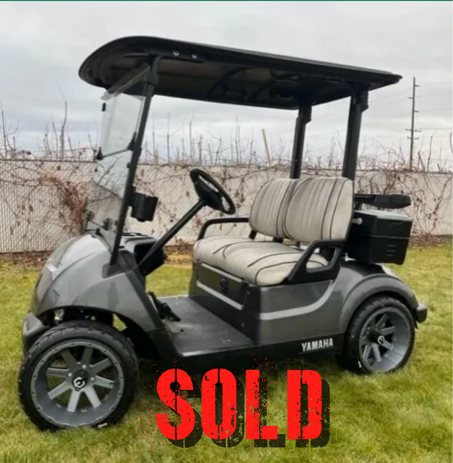 Gray Yamaha golf cart on grass
