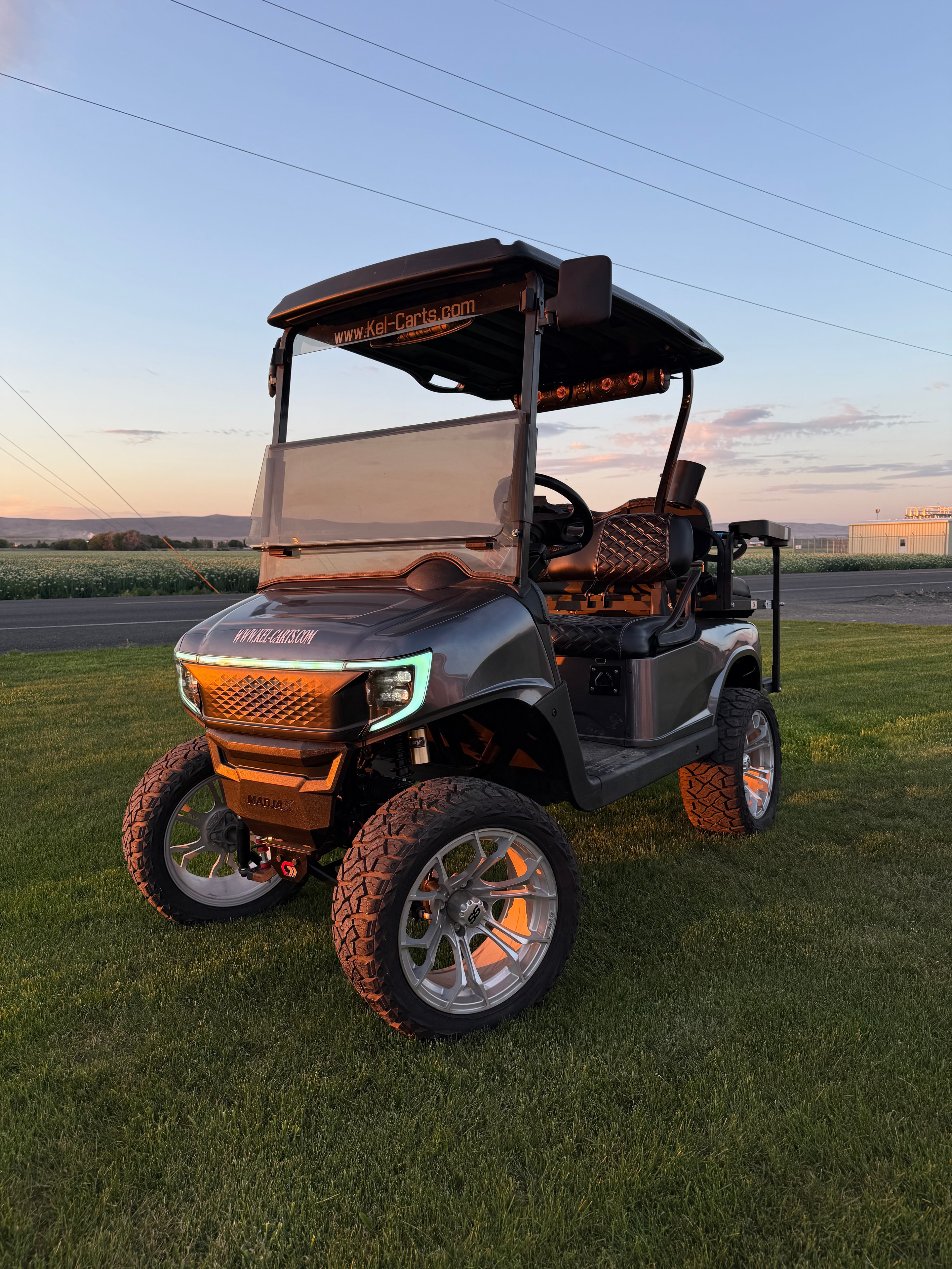 Green utility golf cart with raised dump bed
