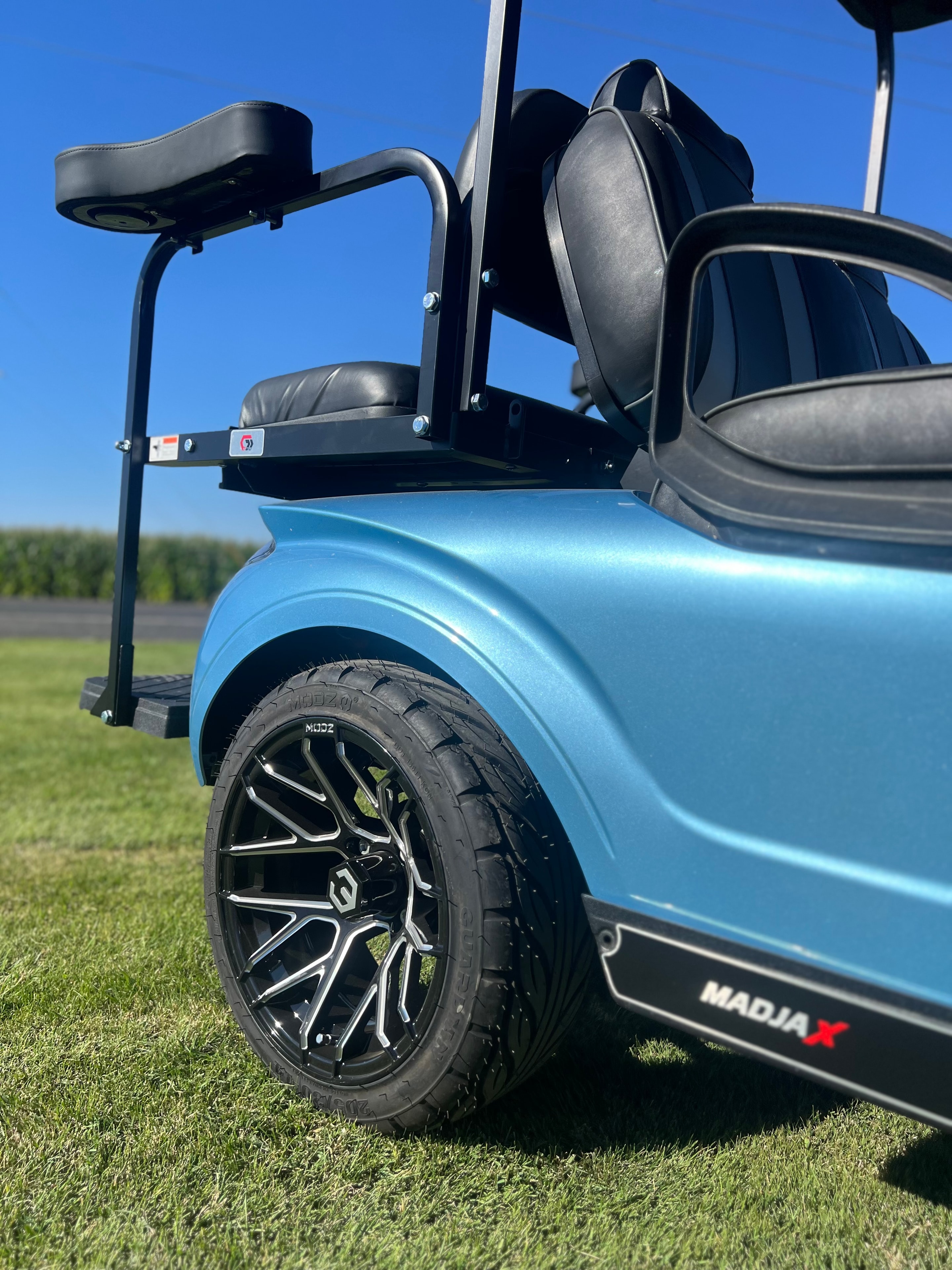 Light blue golf cart with rear-facing seat kit